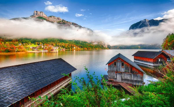 Misty and sunny morning on Altaussee village. Sunny autumn scene in the morning. Location: resort village Altaussee, Liezen District of Styria, Austria, Alps. Europe.