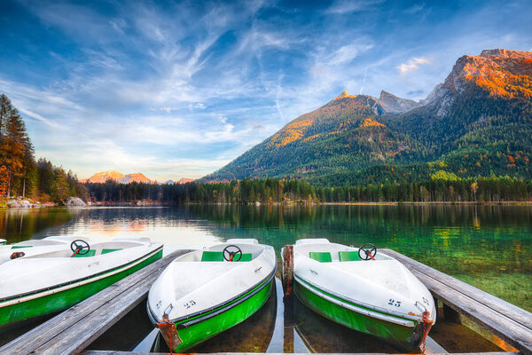 Fantastic autumn evening at Hintersee lake. Few boats on the lake with turquoise water of Hintersee lake. Location: resort Ramsau, National park Berchtesgadener Land, Upper Bavaria, Germany Alps, Europe