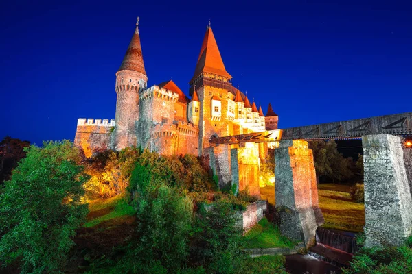 Beautiful night panorama of the Hunyad Castle / Corvin\'s Castle with wooden bridge. Fantastic night scene of castle in Hunedoara, Transylvania, Romania, Europe