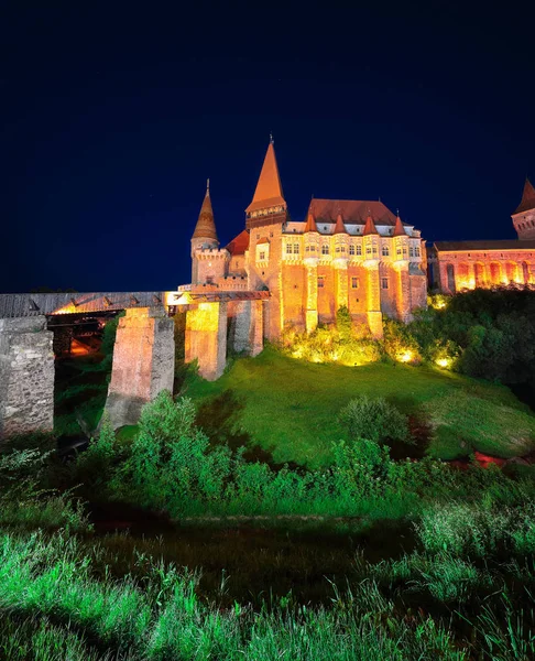 Beautiful night panorama of the Hunyad Castle / Corvin's Castle with wooden bridge. Fantastic night scene of castle in Hunedoara, Transylvania, Romania, Europe