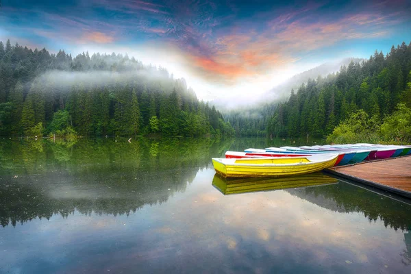 Boats on majestic mountain lake Lacul Rosu or Red Lake or Killer