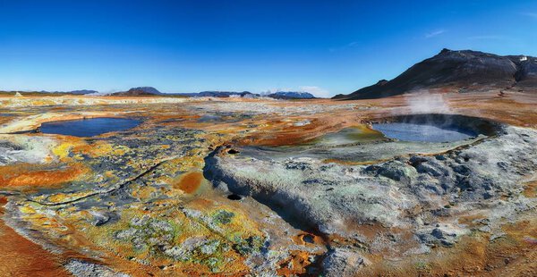 Boiling mudpots in the geothermal area Hverir and cracked ground