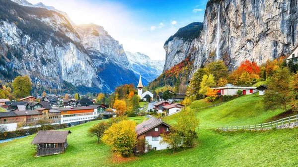 Lauterbrunnen Vadisi 'nin büyüleyici sonbahar manzarası muhteşem Staubbach şelalesi ve arka planda İsviçre Alpleri. Konum: Lauterbrunnen Köyü, Berner Oberland, İsviçre, Avrupa.