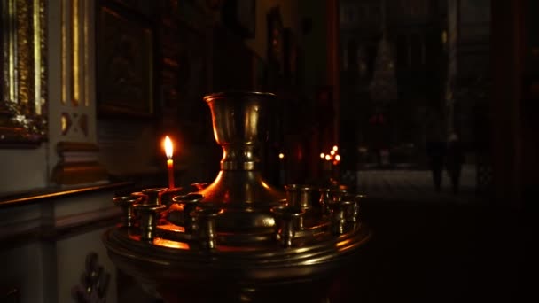 Burning one candle in the temple. Camera pan. Close-up video. — Stock Video