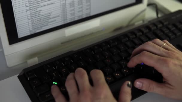 Detective is working on computer in slow motion, hands and keyboard closeup — Stock Video