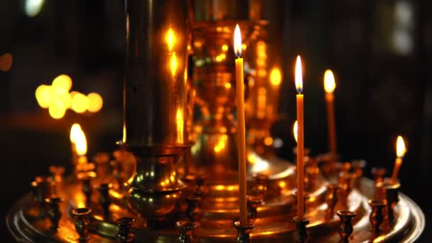 Burning candles in a gold candlestick — Stock Video