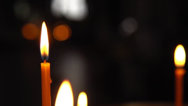 Burning candle close-up on a dark background — Stock Video