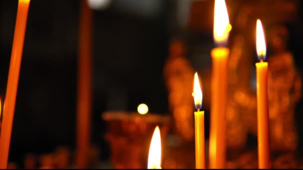 Große brennende Kerzen in Großaufnahme in der orthodoxen Kirche — Stockvideo