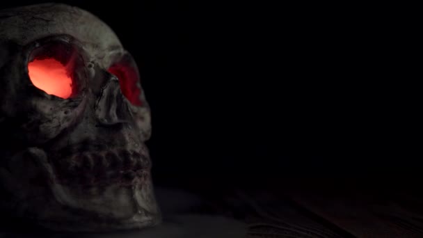发亮的红色眼睛的骷髅，在黑色的背景上发出孤立的烟雾 — 图库视频影像