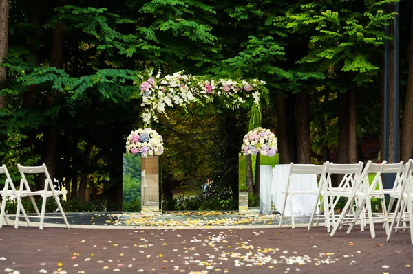 Beautiful wedding decorations. Wedding arch with bouquets for ceremony.