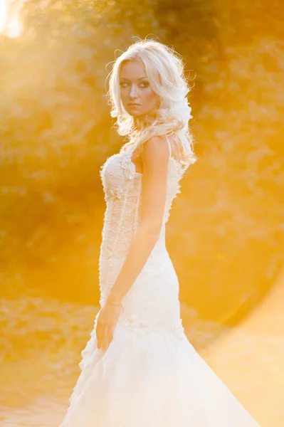 Beautiful sensual bride blonde in wedding dress