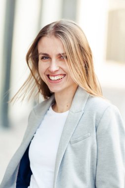 Ofis şirket yakınındaki güzel gülümseyen sarışın genç kadın portresi