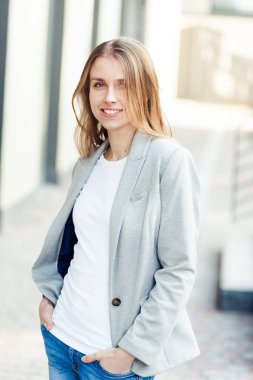 Ofis şirket yakınındaki güzel gülümseyen sarışın genç kadın portresi