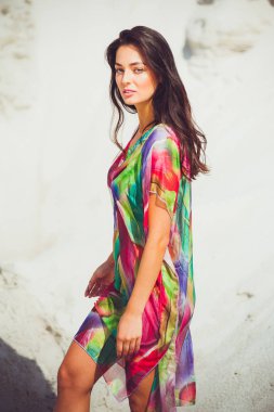 Renkli mayo kum üzerinde güzel genç şehvetli kadın