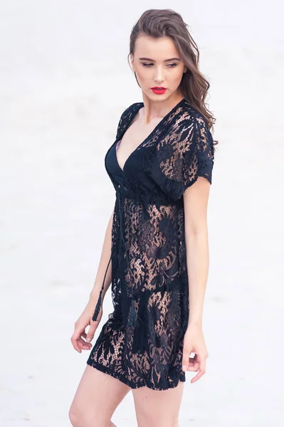 Beautiful young woman posing on the desert sand dune