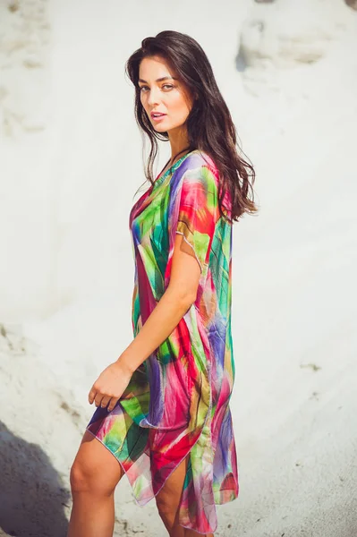 Renkli mayo kum üzerinde güzel genç şehvetli kadın