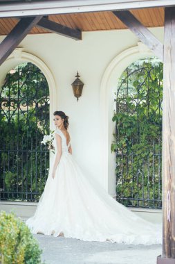 Düğün seremonisinden önce beyaz sarayın yakınında açık renkli, uzun beyaz elbiseli zarif bir kadın yürüyordu..