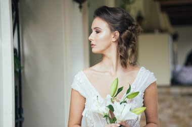 Düğün seremonisinden önce beyaz sarayın yakınında açık renkli, uzun beyaz elbiseli zarif bir kadın yürüyordu..