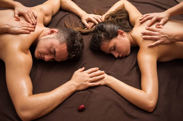 Relaxing massage for a couple in four hands. Four-handed massage is a massage where two therapists work on you at the same time, mirroring each others.