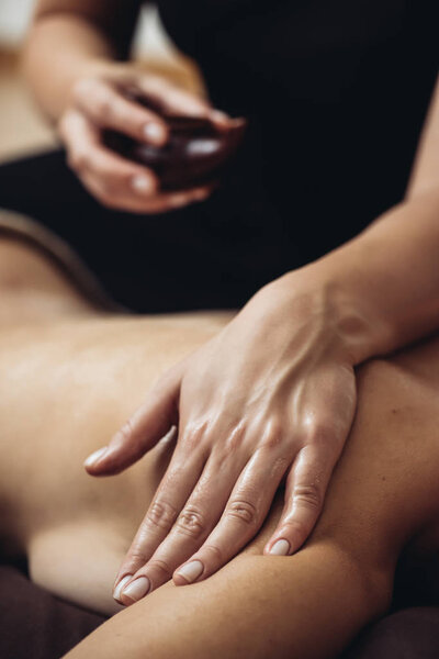 Sensual tantric massage in the cozy atmosphere of a beauty salon by a professional massage therapist