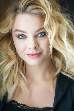 Güzel sarışın, mavi gözlü ve dalgalı saçlı.