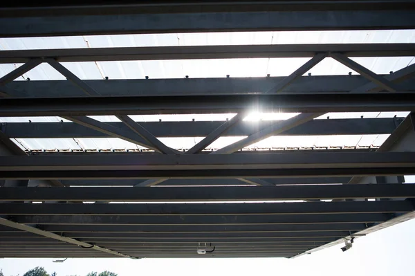 Metal construction for protection from the sun and rain