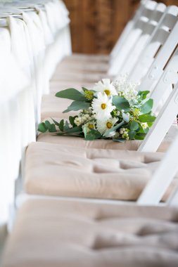white wedding bouquet on a wooden bench. high quality photo