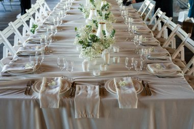 beautiful table with flowers and candles in restaurant.