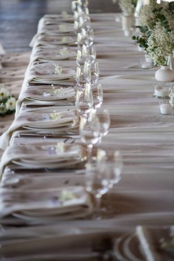wedding table set with flowers, glasses and candles