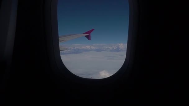 Облака и Гималаи под крылом самолета — стоковое видео