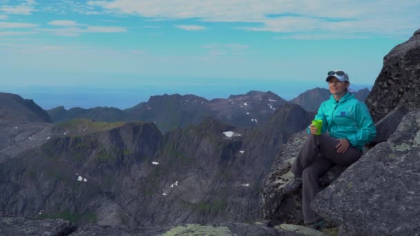 A girl is drinking tea in the mountains — Stock Video