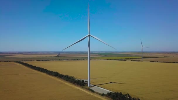 Aerial view of windmills rotating by the force of the wind and generating renewable energy. 4K — Stock Video