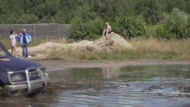 Festival of off-road lovers. SUVs drive the swamp. Cars skid in the mud. — Stock Video