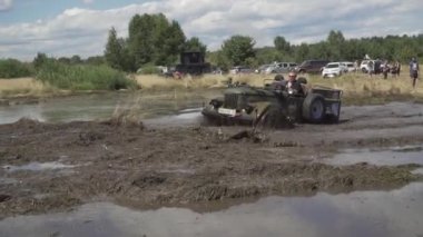 Off-road aşıkları festivali. Cipler bataklığı sürüyorlar. Arabalar çamurda kayar..