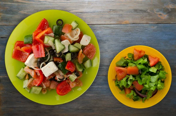 Greek salad on a wooden background . Greek salad on a plate top view . healthy food