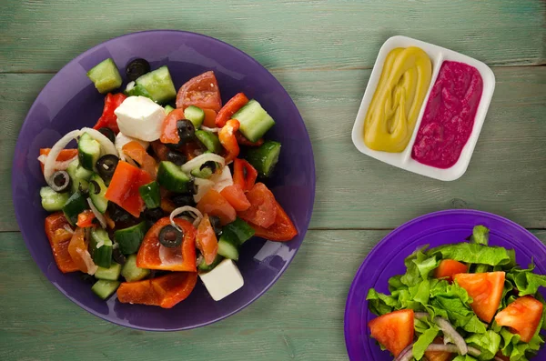 Greek salad on a wooden background . Greek salad on a plate top view . healthy food