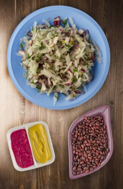 salata daikon, soğan ve bir ahşap zemin üzerine dereotu. bir tabak salata