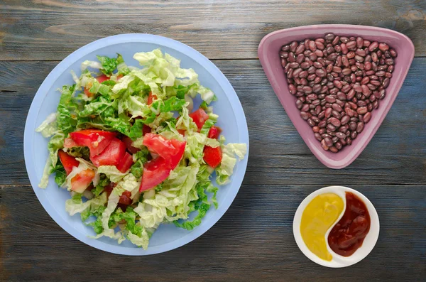 Vejetaryen Gıda. ahşap arka plan üzerinde bir tabakta lahana domates salatası. sağlıklı gıda