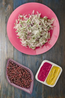 salata daikon, soğan ve bir ahşap zemin üzerine dereotu. bir tabak salata