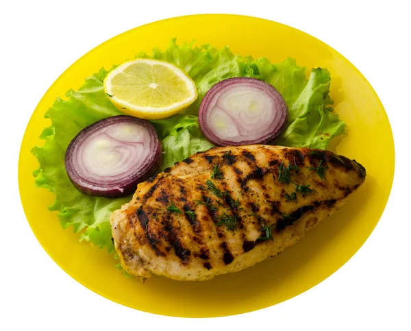 grilled chicken fillet with vegetables (lemon, salad, onion) isolated on white background. chicken fillet grilled on a plate top view
