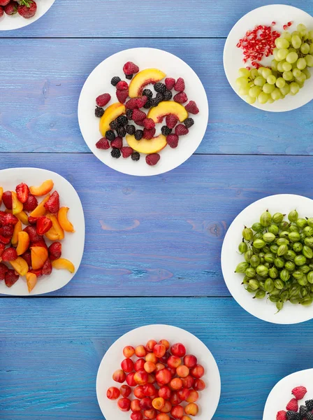 fruits on a plate. vegetarian food on wooden background. vegan food top view .