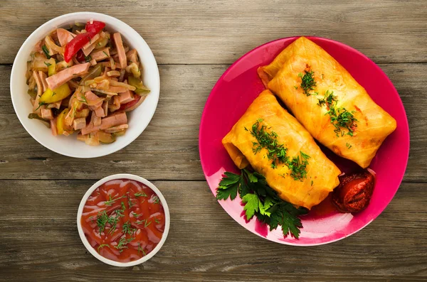 cabbage rolls in a plate. cabbage rolls on a wooden background. meat in cabbage top view.