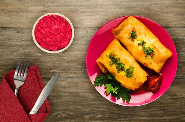 cabbage rolls in a plate. cabbage rolls on a wooden background. meat in cabbage top view.