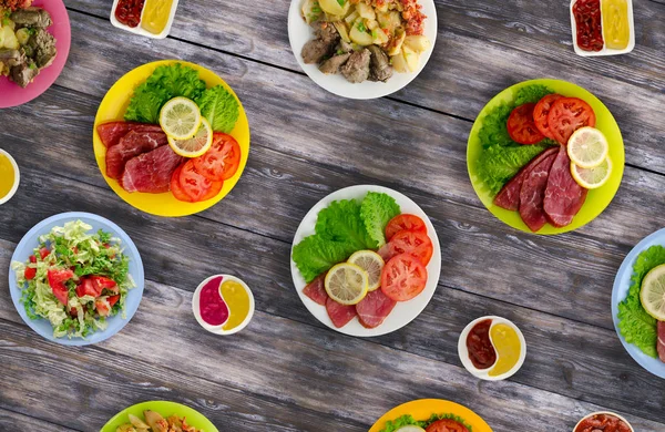 et yemekleri bir plaka üzerinde. bir tabak salata. masaya yiyecek bolluğu. Gıda üstten görünüm