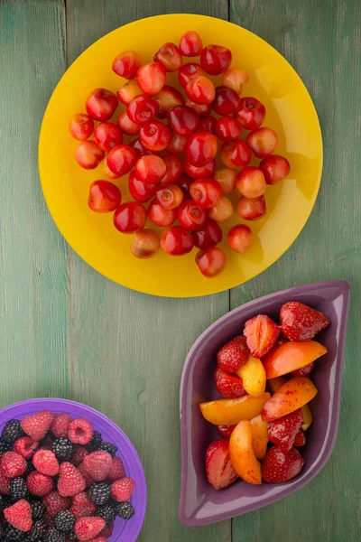 sweet cherry on a plate. sweet cherry on a wooden background. healthy vegetarian food.