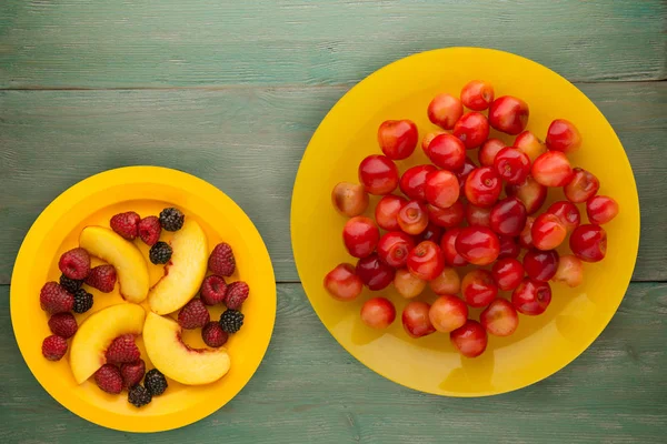 sweet cherry on a plate. sweet cherry on a wooden background. healthy vegetarian food.