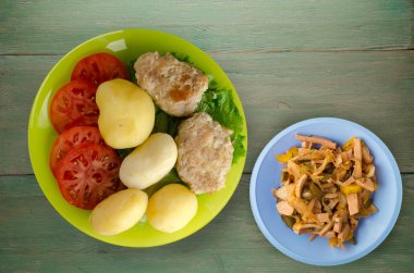  göğsü bir tabak patates ile. göğsü ahşap arka plan üzerinde patates ile