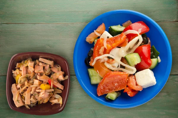 Greek salad on a wooden background . Greek salad on a plate top view . healthy food