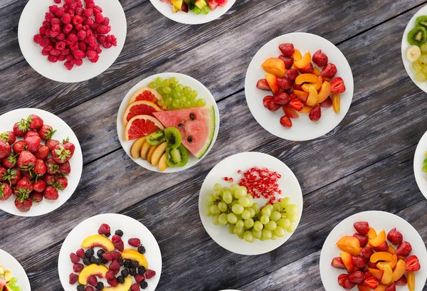 Fruit diet. Fruits on a plate on a wooden background. Healthy food .