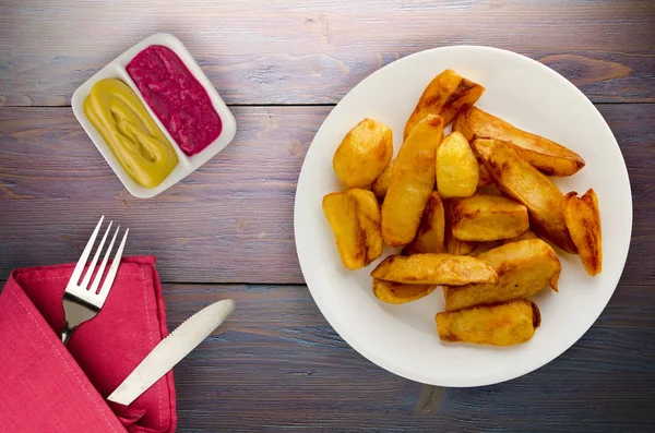 Fry potatoes on a wooden background — Stock Photo, Image